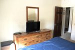 Primary Bedroom with Flat Screen TV and Dresser Storage